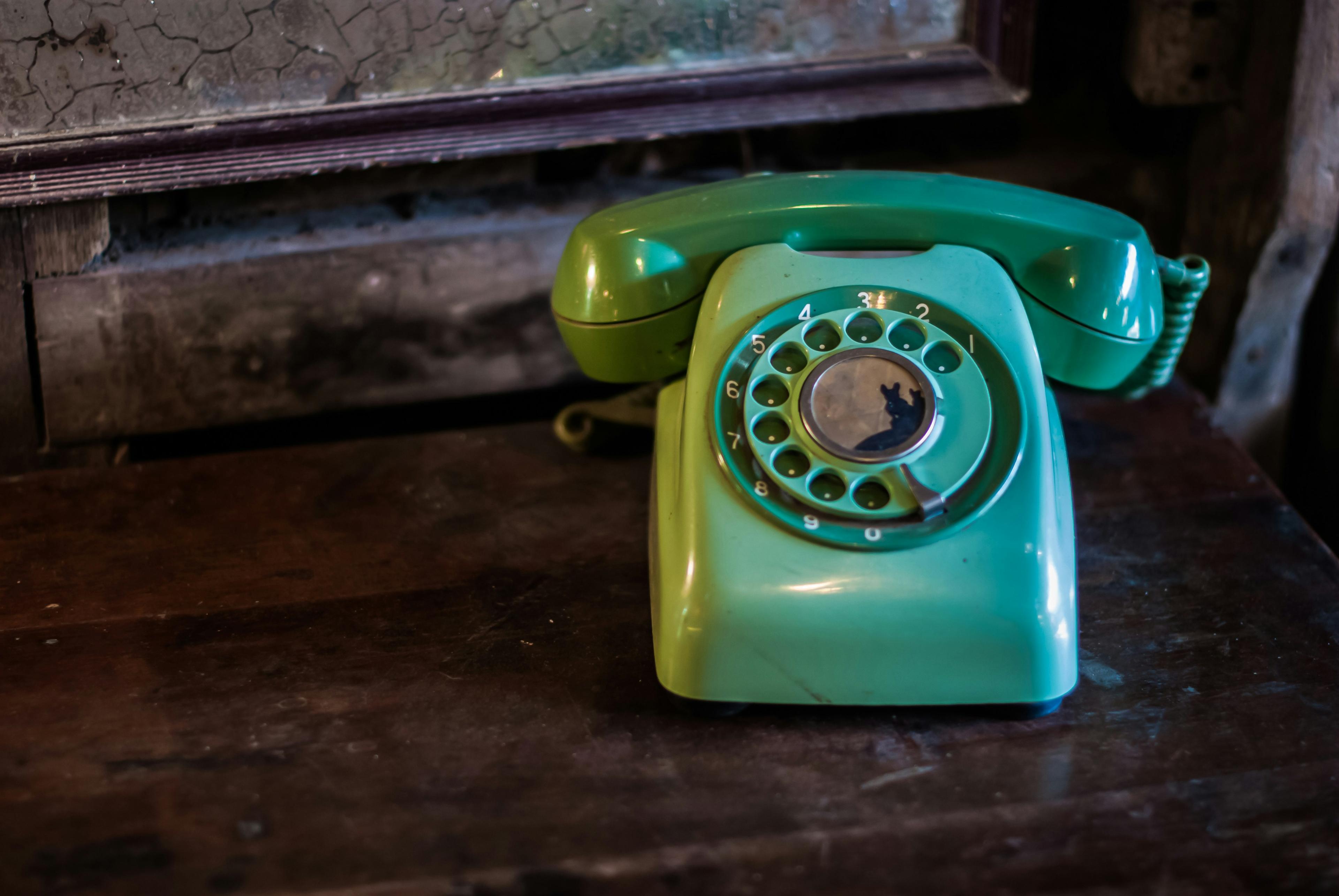 Green vintage phones on table.