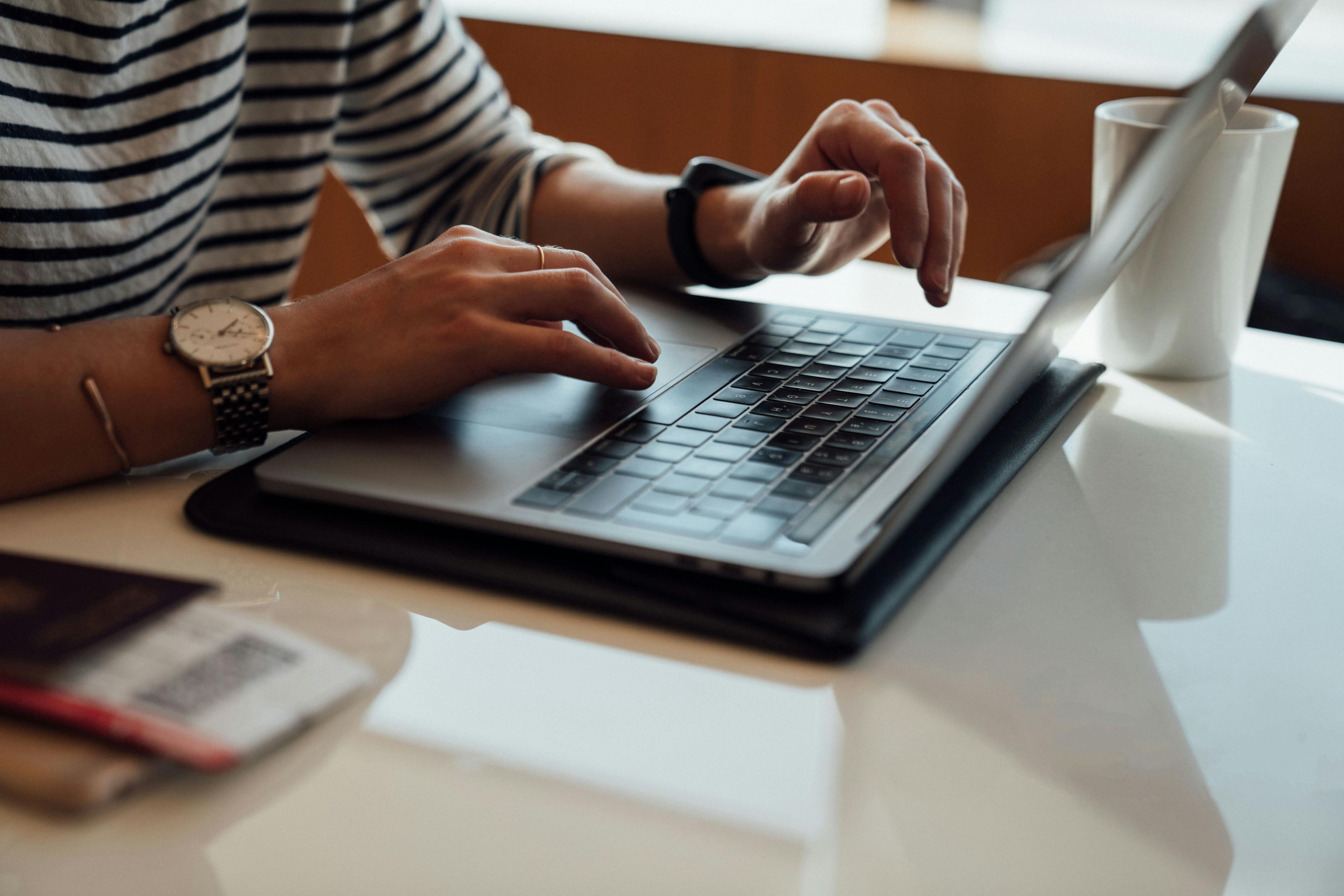 Hands using laptop
