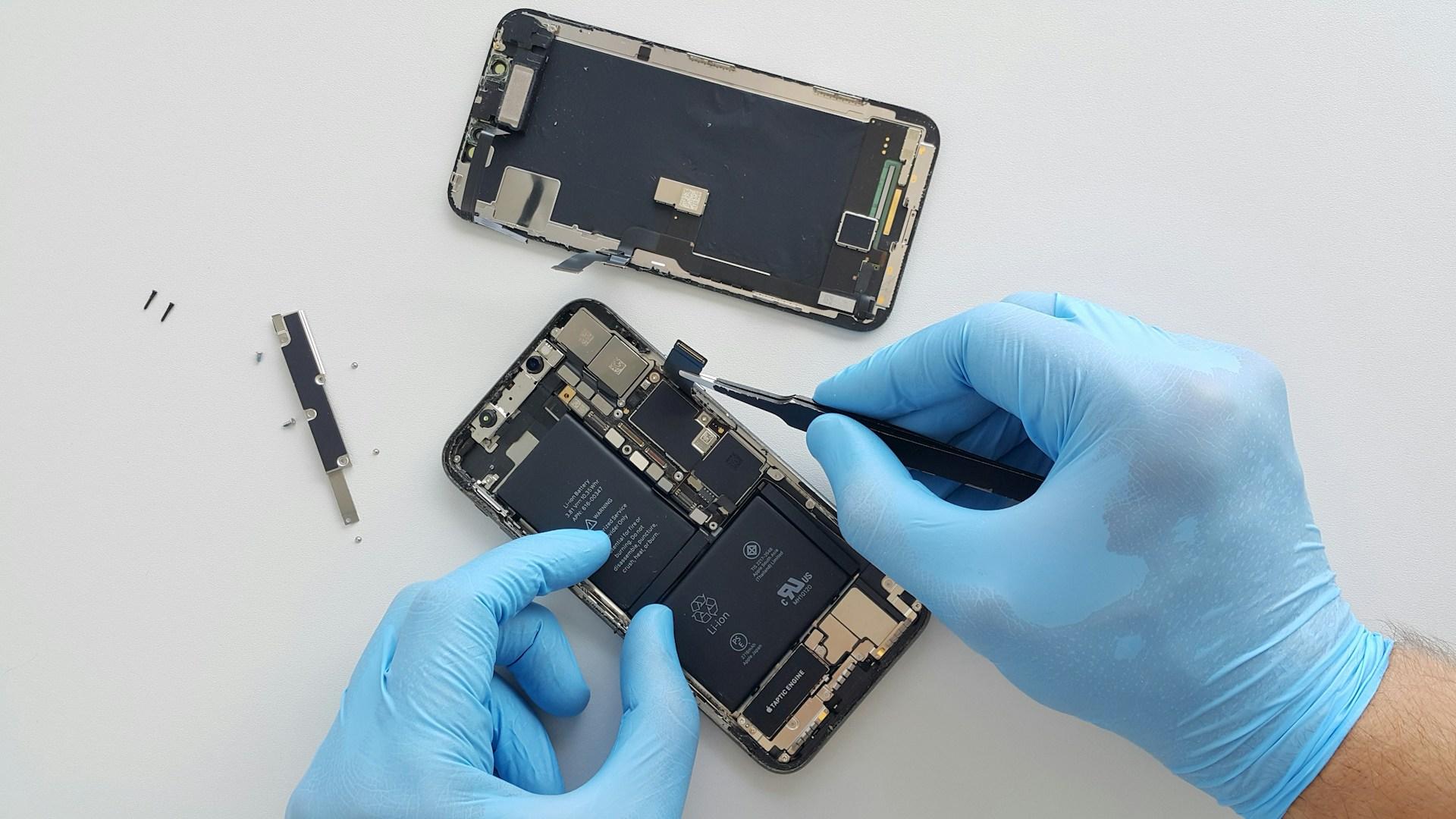 Technician hands working on iphone repair