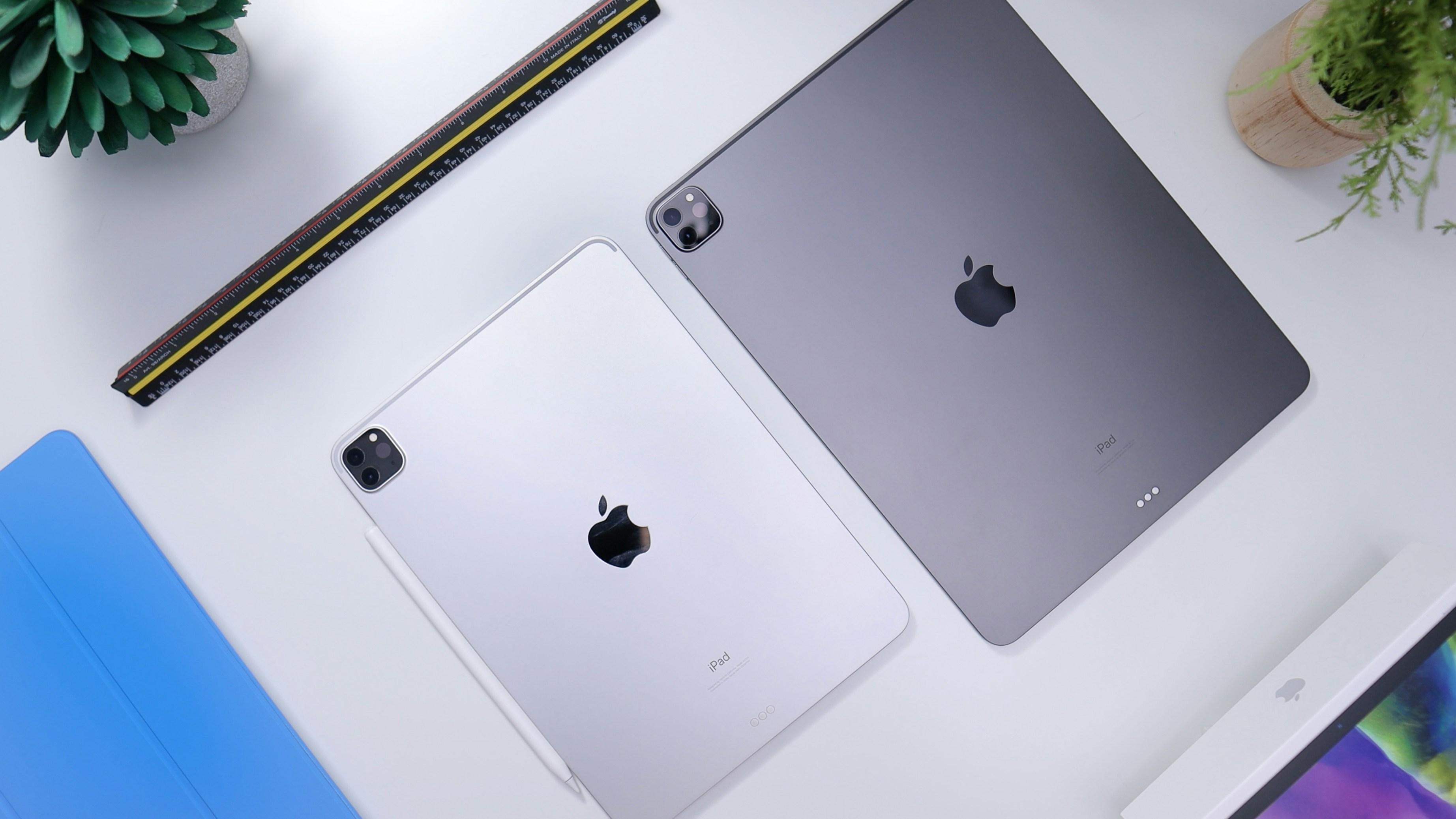 Two iPads face down on white table
