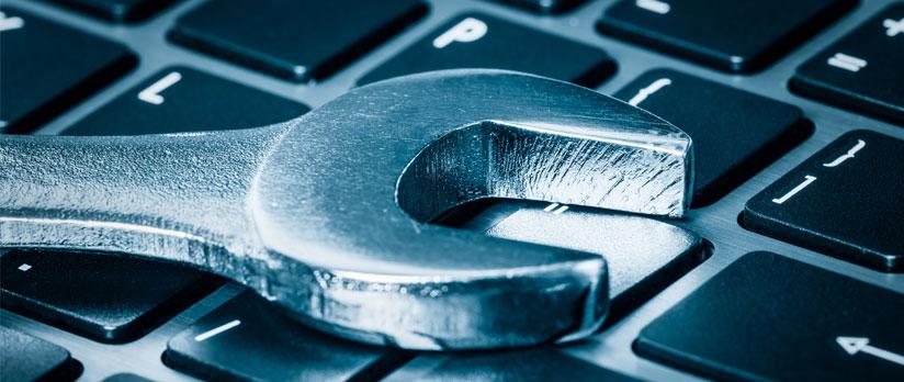 Wrench resting on laptop keyboard
